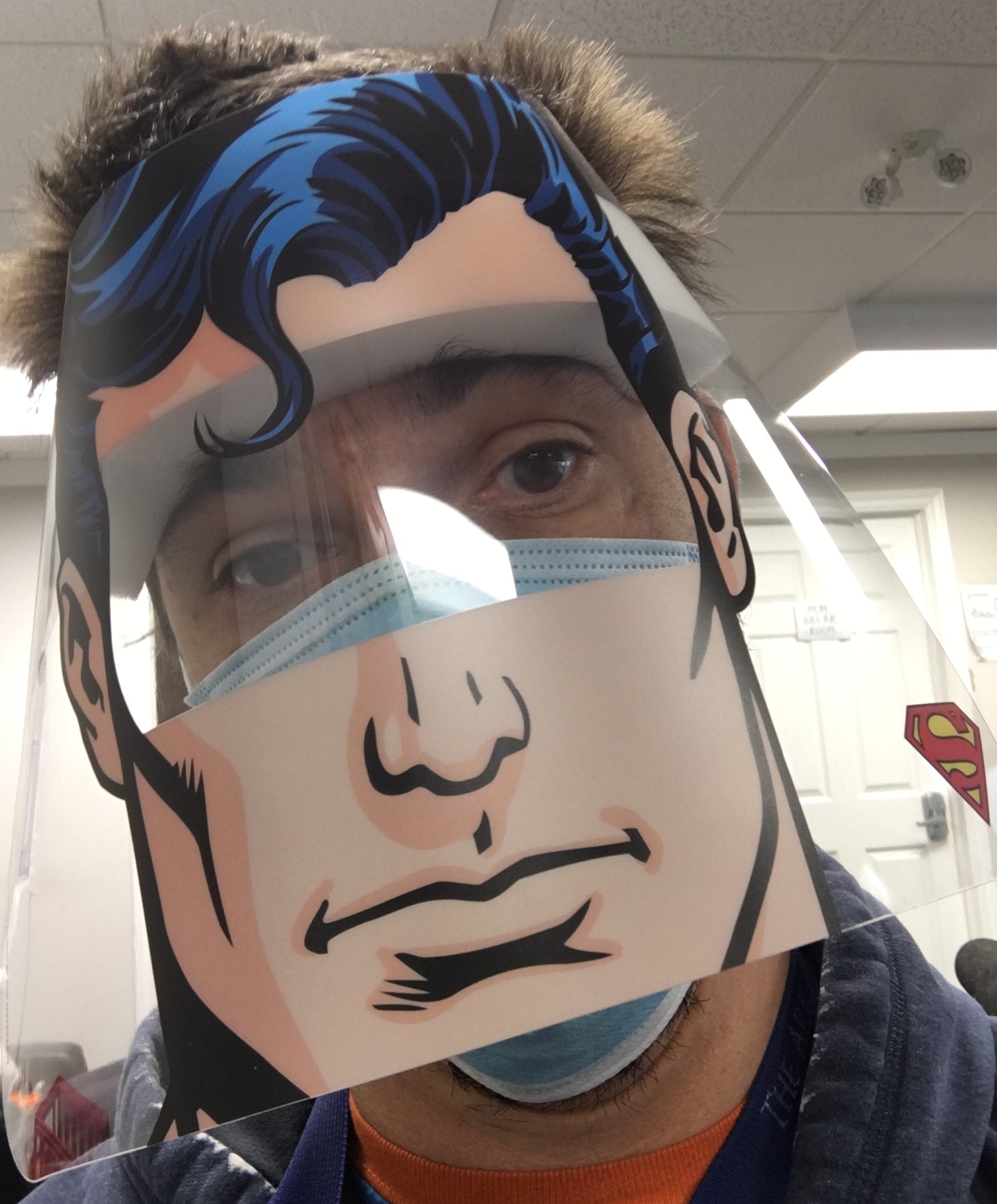 Matt Arguin at a WISH site, wearing a face-mask and a Superman face-shield that he received as a gift from one of the residents 